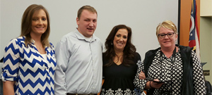 Beth Klosterman, Matthew Evans, and Toni Evans present the Debbie Ewing Memorial Scholarship
