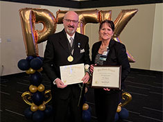 Dennis Kelly and Susan Morris accept Regional hosting award