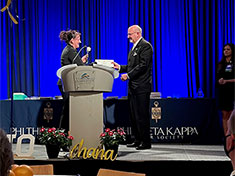 Dennis Kelly receives certificate and symbolic white rose